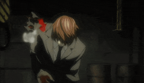 a man in a suit and tie stands in a dark room