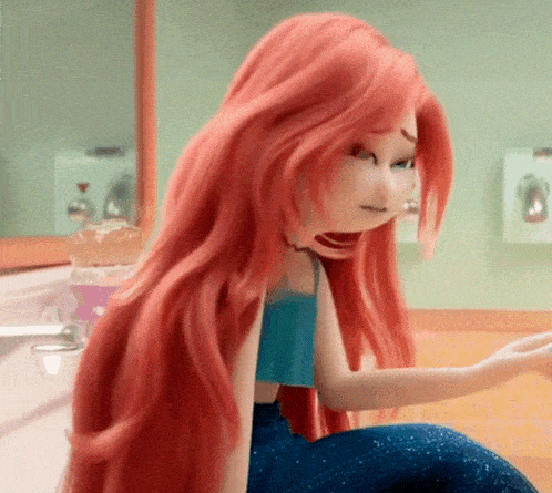 a doll with red hair is sitting in a bathroom