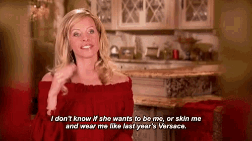 a woman in a red off the shoulder top says i don t know if she wants to be me