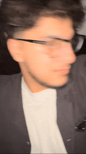 a blurry photo of a man wearing glasses