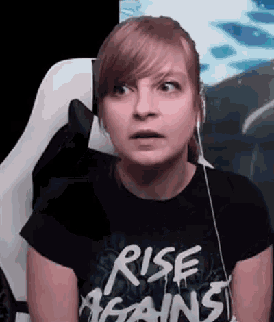 a woman is wearing a black shirt that says rise against