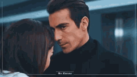 a man and a woman are touching each other 's foreheads .