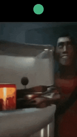 a man in a red shirt is standing next to a microwave