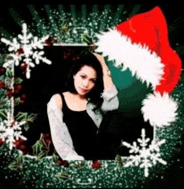 a woman wearing a santa hat is surrounded by snowflakes