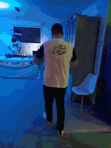 a man standing in a room with a t-shirt that says ' chicago ' on the back