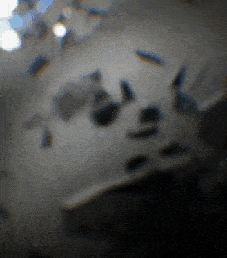 a blurred image of a person 's face with a few spots of light