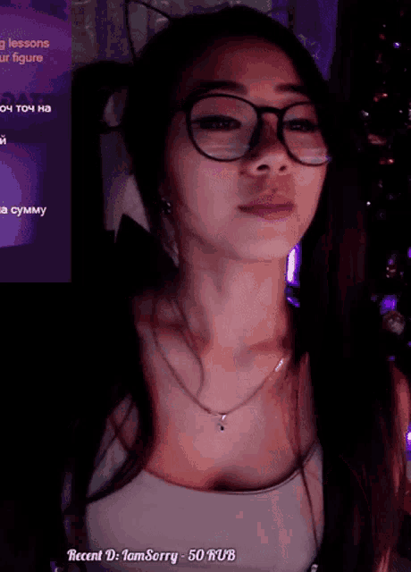 a woman wearing glasses and pigtails is standing in front of a screen that says recent d : iamsorry -50 rub