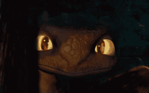 a close up of a dragon 's eyes that are glowing