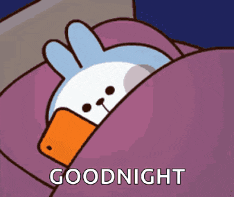a cartoon duck is sleeping in a bed with a cell phone in its beak and the words goodnight below it .