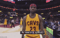 a man in a cavs jersey stands in front of a crowd