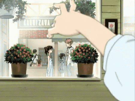 a person 's hand reaches out towards a window with a sign that says karuizawa
