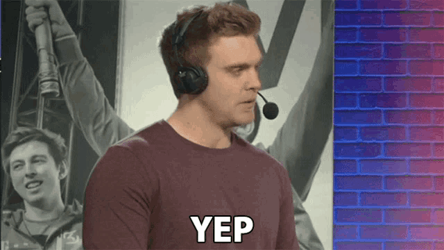 a man wearing headphones with yep written on his chest