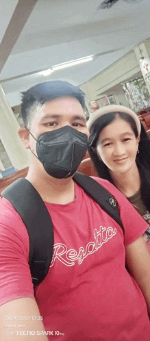a man wearing a red regatta shirt poses with a woman