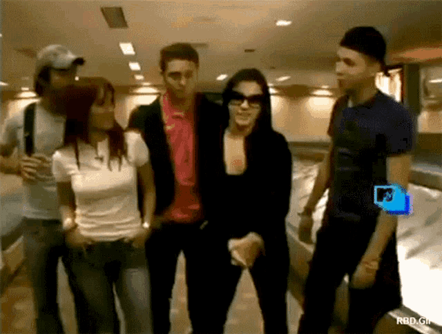 a group of people standing next to each other with a rbd.gif on the bottom left