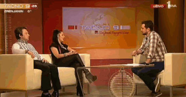 two men and a woman are sitting on a couch in front of a screen that says tacno 91
