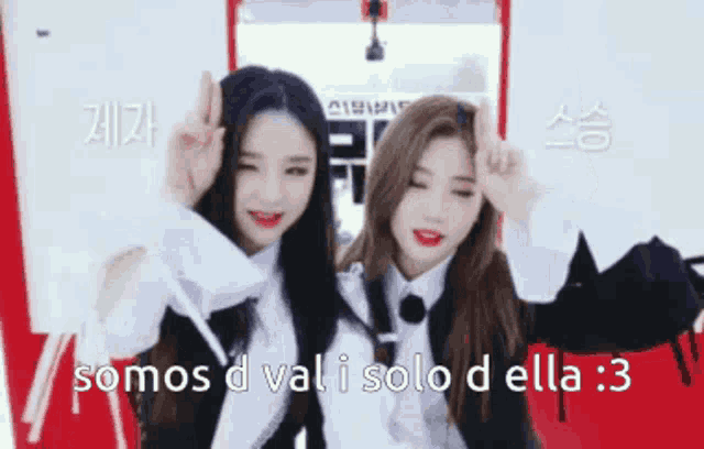 two girls are giving each other a peace sign in spanish