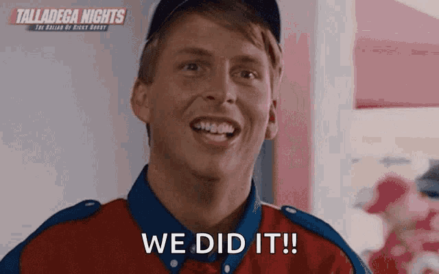 a man in a red shirt and blue hat is smiling and saying we did it