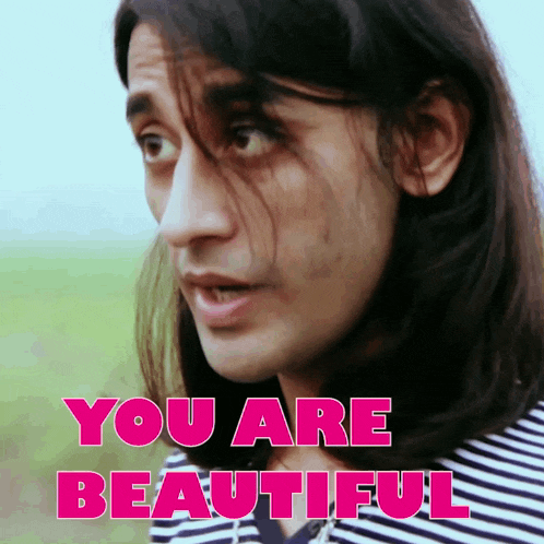 a man with long hair and the words you are beautiful