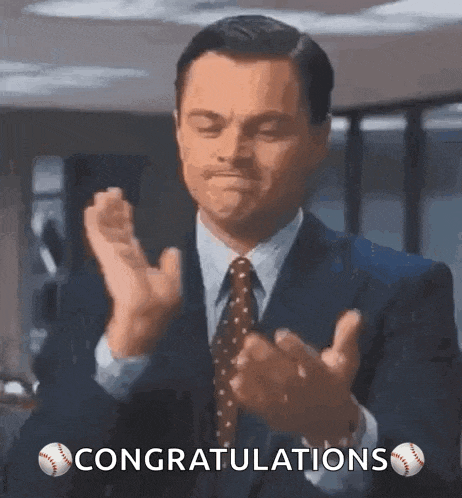 a man in a suit and tie is clapping his hands with the words congratulations below him