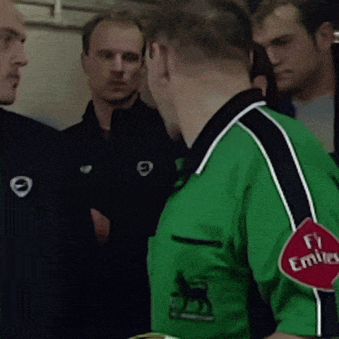 a man wearing a green shirt that says emirates on the sleeve