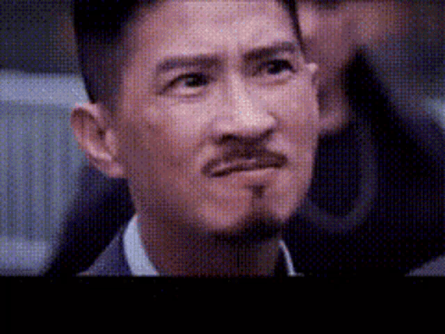 a man with a beard and mustache is looking at something