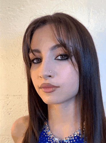 a woman with long hair and a nose ring