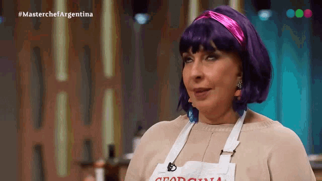 a woman wearing purple hair and an apron that says argentina