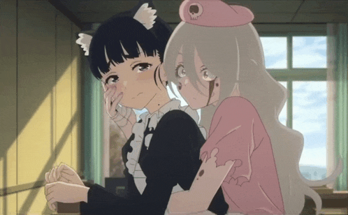 a girl with cat ears is hugging another girl with a skull on her hat