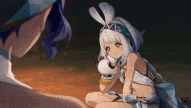 a girl with bunny ears is sitting next to another girl