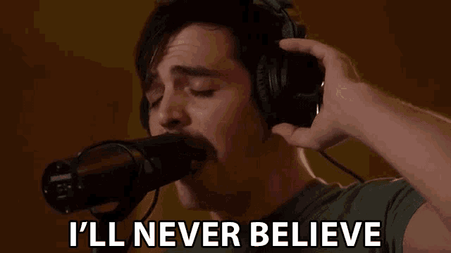 a man singing into a microphone with the words " i 'll never believe " written below him
