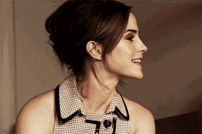 a woman in a plaid shirt is smiling and looking to her left
