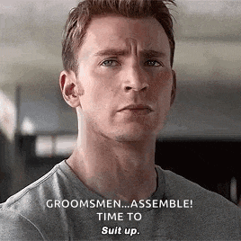 a close up of a man 's face with the words `` groomsmen ... assemble ! time to suit up ! ''