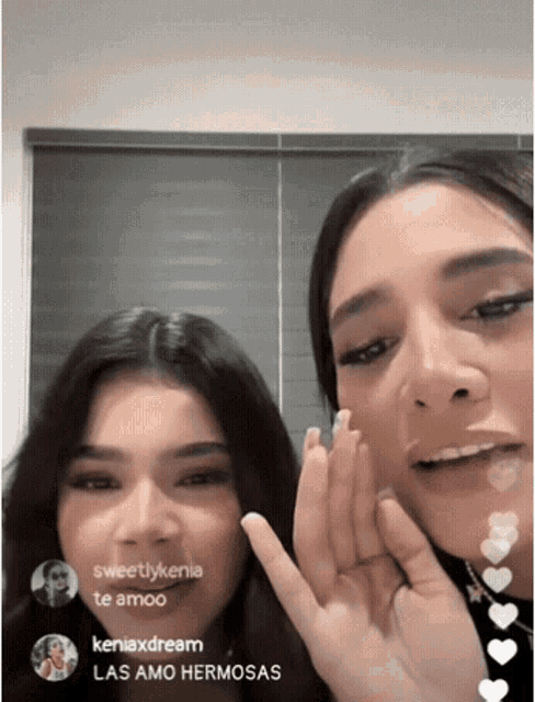 two girls are whispering into each other 's ear and one of them says sweetlykenia te amo