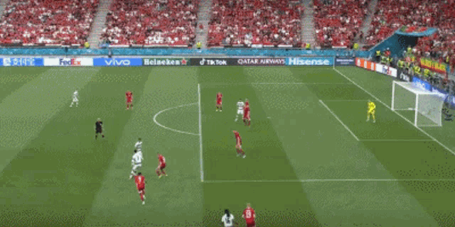 a soccer game is being played on a field with advertisements for fedex and tiktok