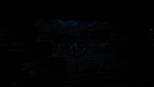 a couple of people walking in a dark forest