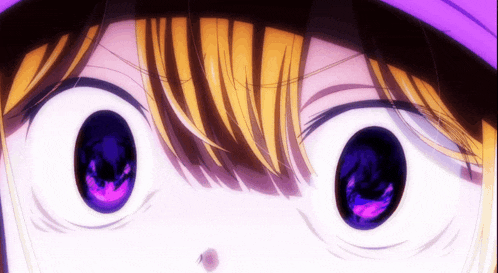 a close up of a person 's eyes with a purple pupil