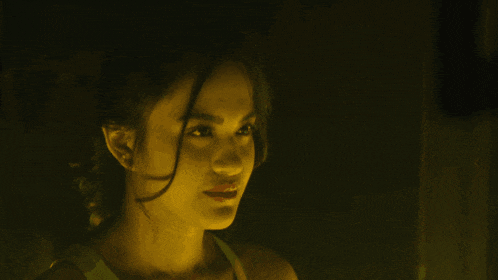 a close up of a woman 's face in a dark room