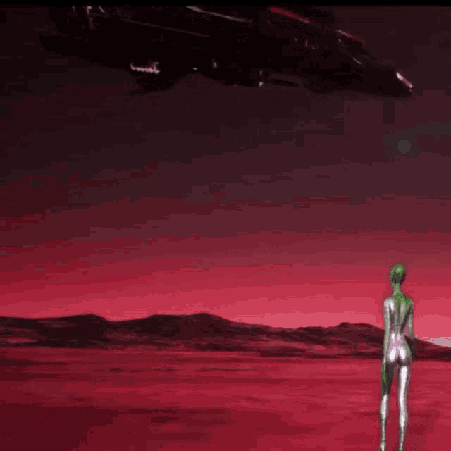 a woman in a silver bodysuit stands in front of a black space ship