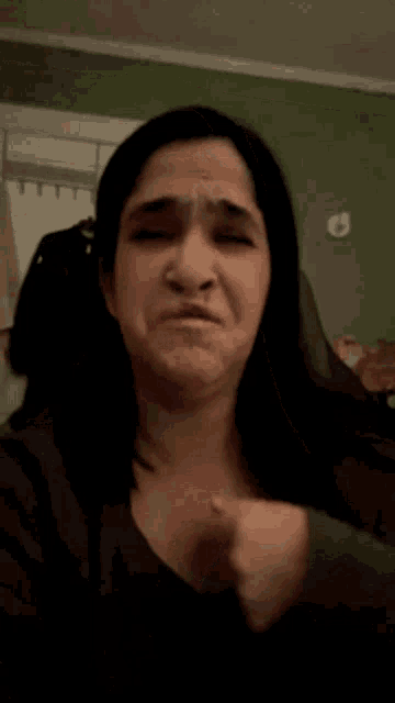 a woman making a funny face with her hands