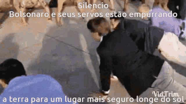 a man is doing push ups in front of a crowd of dogs with the caption silencio bolsonaro