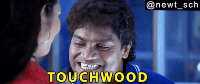 a man and a woman are looking at each other and the words touchwood are on the screen