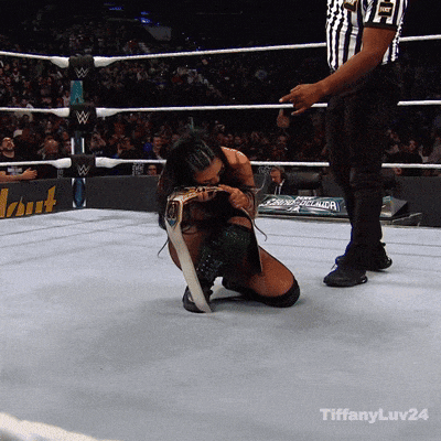 a woman is kneeling down in a wrestling ring with tiffanyluv24 on the bottom
