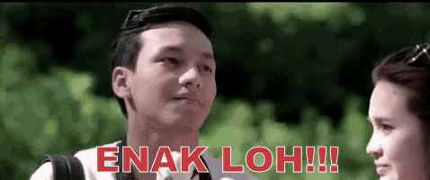 a man and a woman are standing next to each other and the man is saying enak loh .