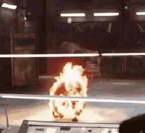 a person is watching a fire explosion through a window