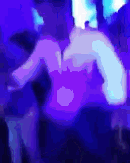 a blurry photo of a person dancing in a dark room