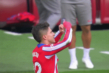 a soccer player wearing a red and white jersey with the number 2 on it is standing on the field .