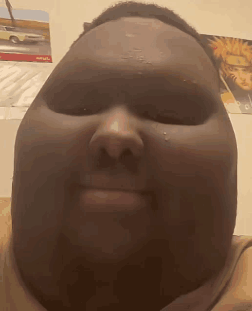 a close up of a person 's face with a picture of a car on the wall behind him that says shuttle