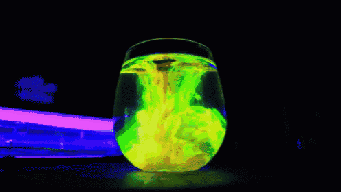 a glass filled with a yellow liquid that looks like a tornado coming out of it
