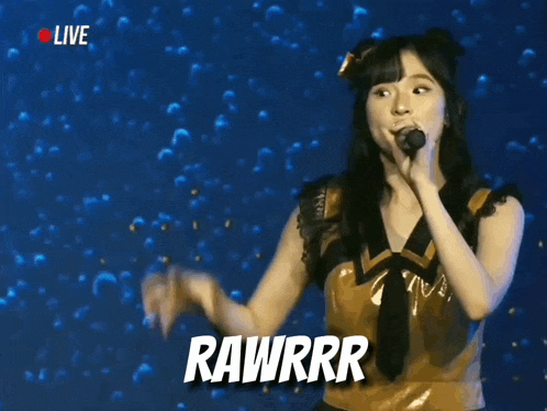 a woman singing into a microphone with the word rawrr written on the bottom