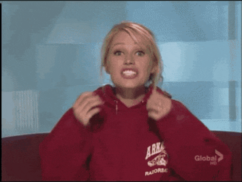 a woman is wearing a red hoodie that says ark razorback
